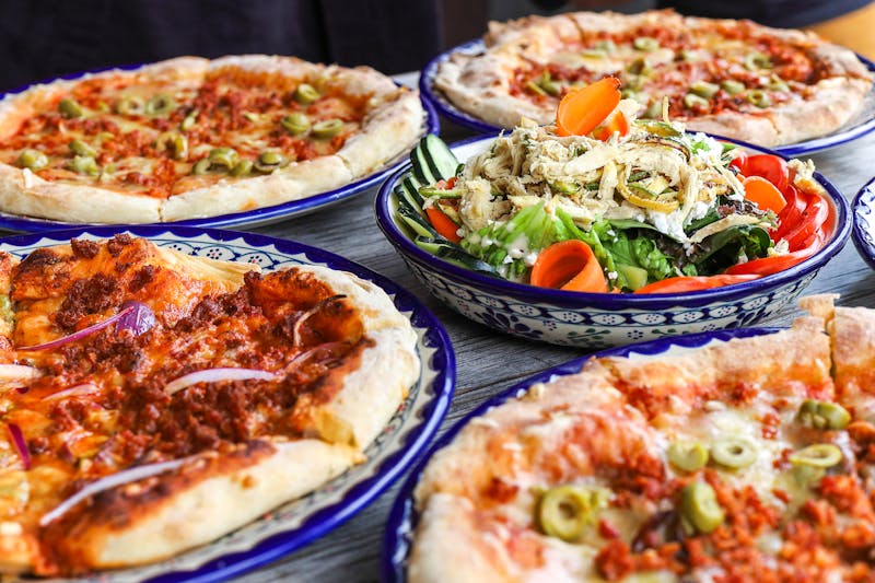 Rich house-made pizza sauce being prepared