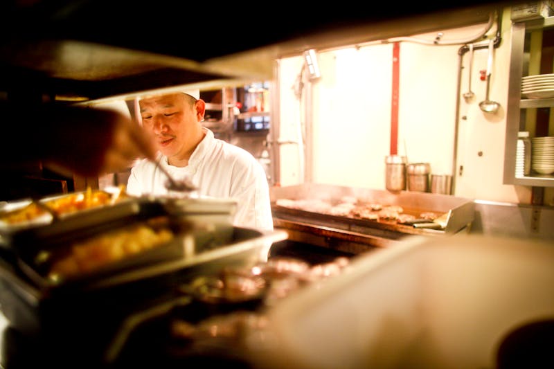 Professional kitchen area with chefs preparing food